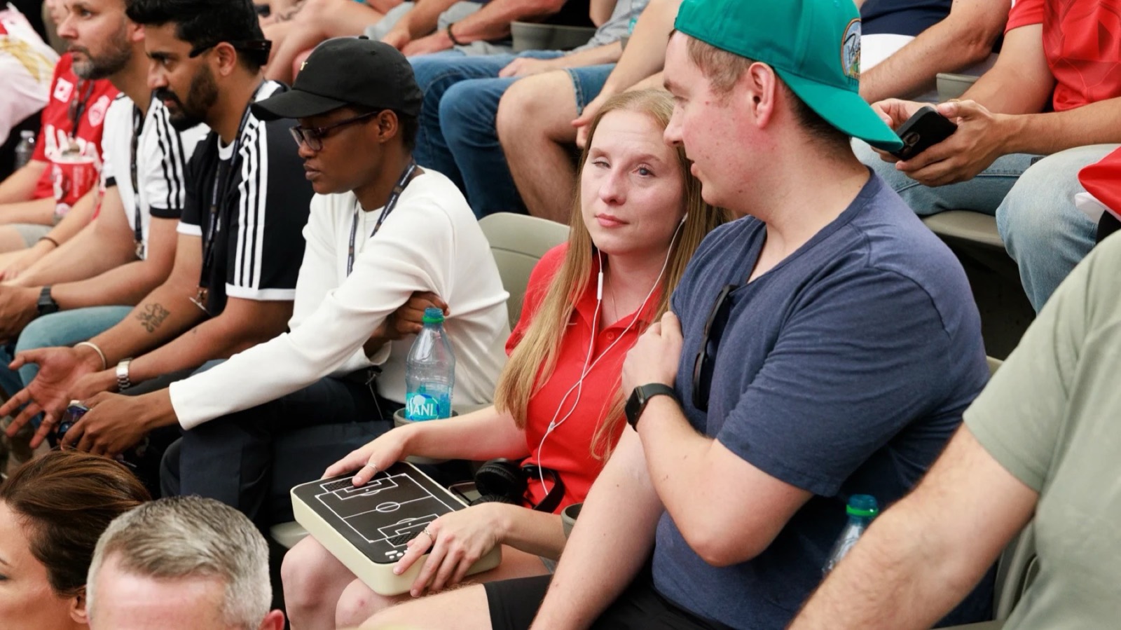A low-vision fan follows a World Cup match using a tactile board
